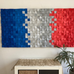 May include: A wall art piece made of squares in blue, white, and red, resembling the French flag. The squares are arranged in a staggered pattern, creating a textured effect.
