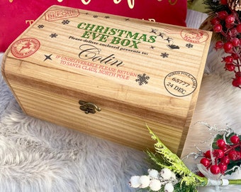 May include: A rectangular wooden box with a metal latch, featuring printed text that reads Christmas Eve Box, Please deliver enclosed presents to: Colin, If undeliverable please return to Santa Claus, North Pole, and North Pole, Alaska 65777 24 Dec.