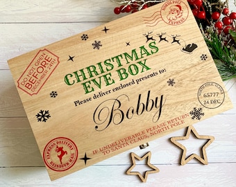 May include: A rectangular wooden Christmas Eve box featuring printed text and graphics including a North Pole Express stamp, a reindeer silhouette, snowflakes, and the name Bobby. It includes a Do Not Open Before December 24th stamp.