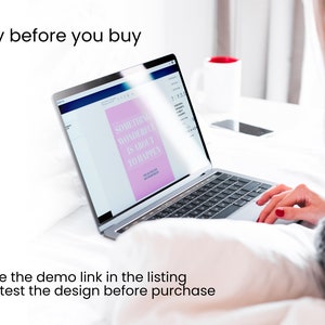 May include: A laptop computer displaying a pink and white design with the text "Something Wonderful Is About To Happen". The laptop is on a white bedspread.