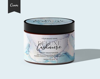 May include: A blue and white jar of body moisturizer with the text "Deluxe Cashmere" and "Body Moisturizer" on the label. The jar is 340g or 13.4oz.