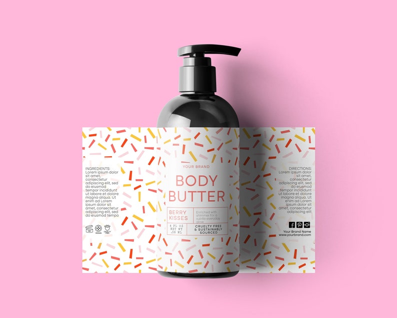 May include: A black bottle of body butter with a white label. The label has a red, yellow, and pink confetti pattern. The text on the label reads "Your Brand Body Butter Berry Kisses Cruelty Free & Sustainably Sourced".
