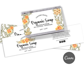 May include: A white label with a floral design and the text "Organic Soap" with the words "Orange Blossom" and "All Natural - Handmade" and "340g - 13.4oz" printed on it. The label is for a bar of soap.