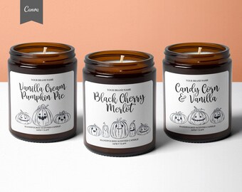 May include: Three amber glass candle jars with white labels. The labels feature a black and white illustration of pumpkins with faces. The candle scents are Vanilla Cream Pumpkin Pie, Black Cherry Merlot, and Candy Corn & Vanilla. Each label reads "Handpoured Scented Candle 340g e 12 oz."