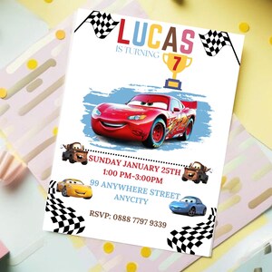 May include: A red, white, and blue birthday invitation with a cartoon race car. The invitation says "Lucas is turning 7" and includes a checkered flag design. The invitation also includes the date, time, and location of the party.