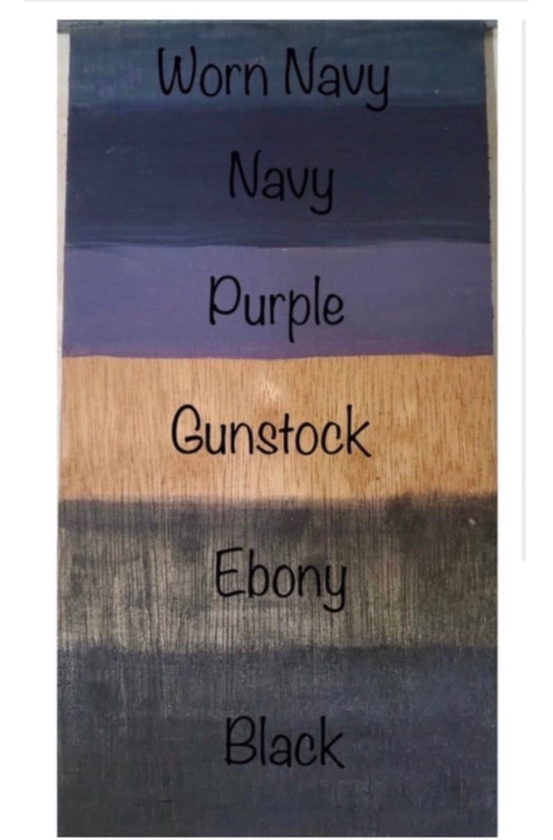 May include: Six wood stain samples in different shades of blue, purple, brown, and black. The samples are labeled "Worn Navy", "Navy", "Purple", "Gunstock", "Ebony", and "Black".