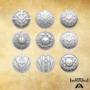 May include: Nine silver metal round shields with different designs. Each shield features a raised bull's head in the centre. The shields are arranged in a 3x3 grid.