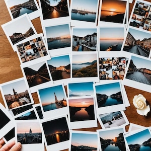 May include: A collection of instant photos in various sizes and colors, displayed on a wooden surface. The photos depict a variety of scenes, including landscapes, cityscapes, and people.