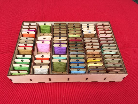 DMC embroidery floss storage and display. Floss wrapped in clothes pins. I  used a barn wood fr…