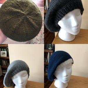 May include: Four knitted berets in different colors: olive green, dark gray, light gray, and navy blue with a white brim. Each beret is displayed on a white mannequin head, showcasing the texture and shape of the hats.