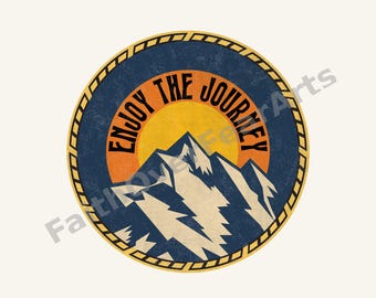 May include: A circular sticker featuring a mountain range in white and dark blue against a yellow sun and orange sky. The text ENJOY THE JOURNEY is printed in black along the top curve. The design is bordered by a yellow and black rope pattern.