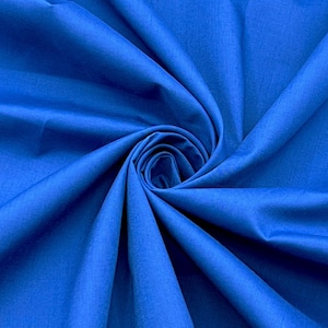 May include: A close-up shot of a vibrant blue fabric, tightly swirled to create a spiral effect. The fabric has a smooth texture and a rich, saturated color, with subtle variations in tone due to the folds and shadows.