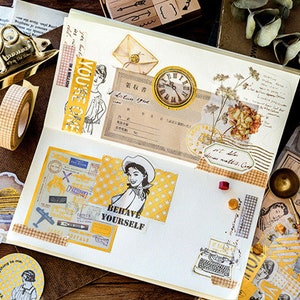 May include: A scrapbook layout with vintage-style ephemera. Includes stickers, washi tape, and paper with illustrations, text, and a clock. The text "BEHAVE YOURSELF" is visible. The color scheme is gold, white, and brown.