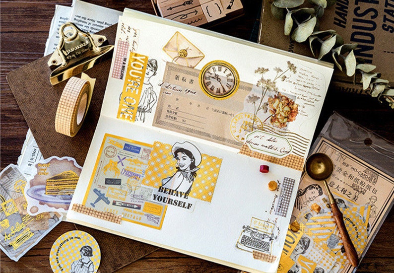 May include: A scrapbook layout with vintage-style ephemera. Includes stickers, washi tape, and paper with illustrations, text, and a clock. The text "BEHAVE YOURSELF" is visible. The color scheme is gold, white, and brown.