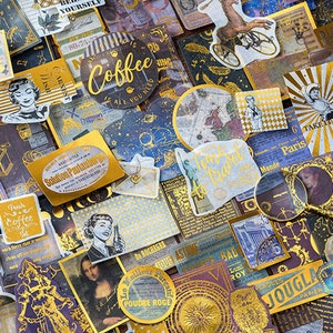 May include: A collection of vintage-style stickers and ephemera in shades of gold, purple, and blue. The stickers feature illustrations, text, and graphics, including a coffee cup, a woman's portrait, and the text "Take it easy".