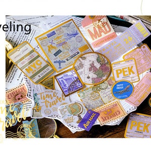 May include: A collection of vintage-style travel ephemera, including tickets, stamps, and tags. The items feature travel-related text and graphics, such as maps, airplanes, and the Statue of Liberty. The word "Traveling" is visible.