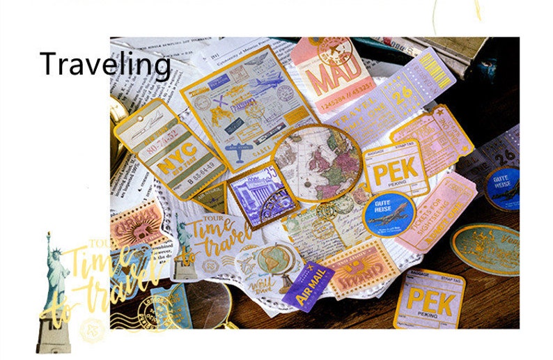 May include: A collection of vintage-style travel ephemera, including tickets, stamps, and tags. The items feature travel-related text and graphics, such as maps, airplanes, and the Statue of Liberty. The word "Traveling" is visible.