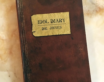 May include: A brown leather-bound journal with a gold label that reads "Idol Diary Dr. Jones".