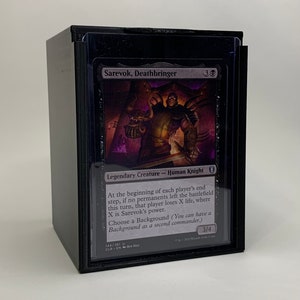 May include: A black bordered card with a purple background featuring a fantasy illustration of a human knight holding a skull. The card text reads "Sarevok, Deathbringer" and "Legendary Creature - Human Knight". The card has a power and toughness of 3/4.