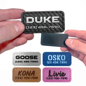 May include: A rectangular patch with a carbon fiber texture featuring the text DUKE and the phone number (123) 456-7890. Additional patches are shown in silver, blue, brown, and pink, each displaying a name and the phone number (123) 456-7890.