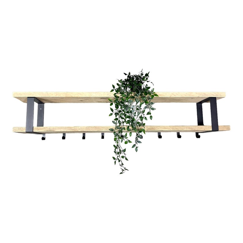 May include: A wooden shelf with black metal brackets and hooks. The shelf has two tiers and is decorated with a hanging plant.