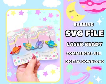 May include: Earrings with planet designs in orange, yellow, purple, and blue, each with a silver hook. The earrings are displayed on a card with the text "Smiley Moon Studio". The image also includes the text "SVG FILE" and "DIGITAL DOWNLOAD".
