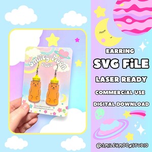 May include: A digital download SVG file of a pair of gummy bear earrings. The earrings are laser ready and can be used for commercial purposes. The image shows a pair of yellow and orange gummy bear earrings on a card with the text "Smiley Moon Studio".