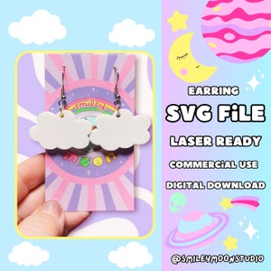 May include: White cloud shaped earrings with silver hooks. The earrings are on a pink and purple background with the text "smiley moon" and a cartoon moon and planet. The text "EARRING SVG FILE LASER READY COMMERCIAL USE DIGITAL DOWNLOAD" is on the right side of the image. The text "@smileymoonstudio" is at the bottom of the image.