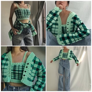 May include: A green and black plaid cropped cardigan and matching tank top. The cardigan has a V-neck and long sleeves. The tank top has a scoop neck and is sleeveless.