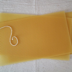 May include: Three sheets of yellow beeswax foundation for beekeeping. The foundation is made of a honeycomb pattern and is used to help bees build their honeycomb.