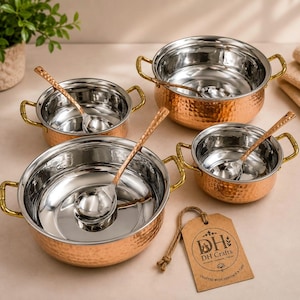 May include: A set of three round serving bowls with hammered copper exteriors and polished stainless steel interiors. Each bowl features two gold-toned side handles and a matching hammered copper spoon. A brown paper tag displays the text DH Crafts.