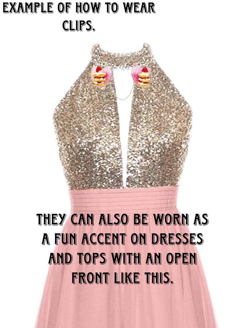 May include: A pink dress with a gold sequined top. The dress has a deep V-neckline and is styled with two small cake-shaped clips on the neckline. The text "EXAMPLE OF HOW TO WEAR CLIPS." is at the top of the image. The text "THEY CAN ALSO BE WORN AS A FUN ACCENT ON DRESSES AND TOPS WITH AN OPEN FRONT LIKE THIS." is at the bottom of the image.