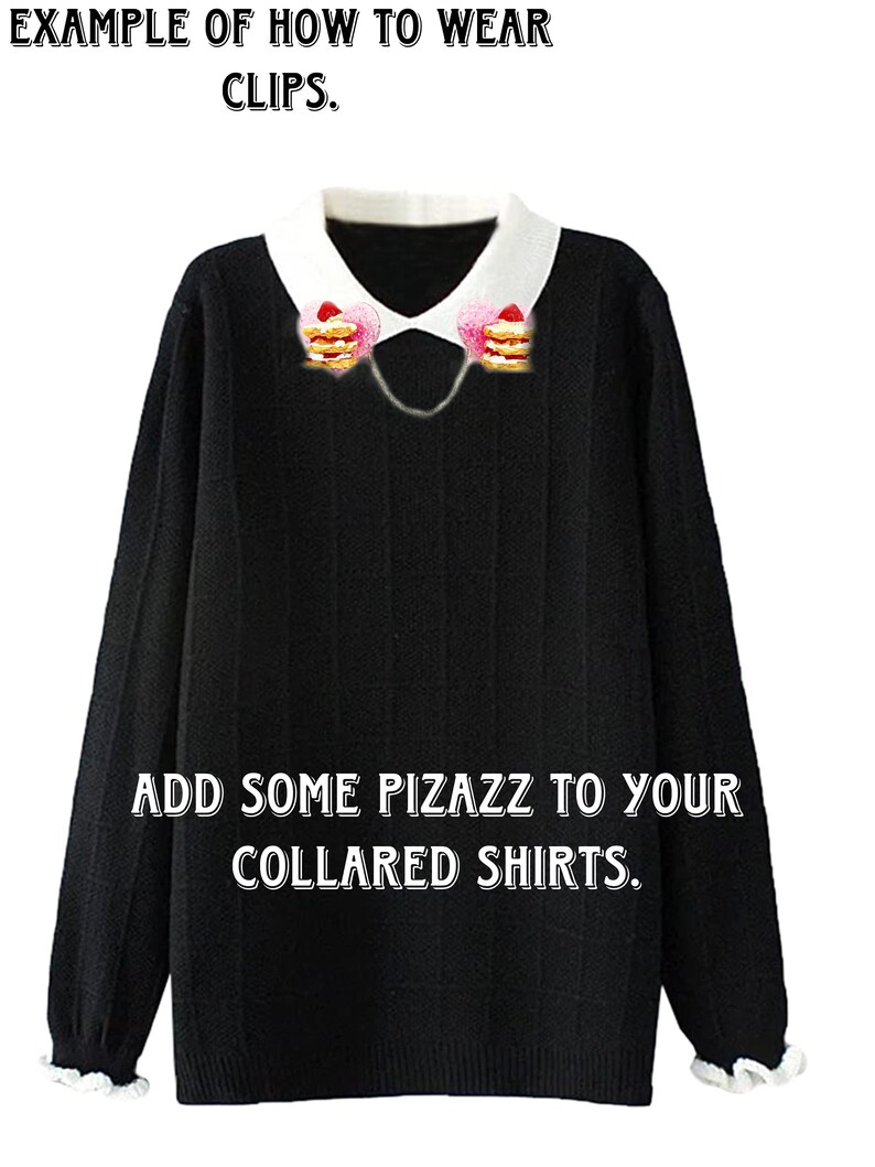 May include: A black sweater with a white collar and a chain with two strawberry and cream pancake charms attached to the collar. The text "EXAMPLE OF HOW TO WEAR CLIPS." is at the top of the image. The text "ADD SOME PIZAZZ TO YOUR COLLARED SHIRTS." is at the bottom of the image.