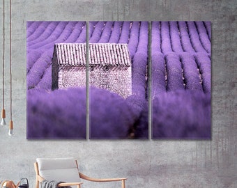 May include: A three-panel canvas print featuring a stone building in a field of purple lavender flowers.