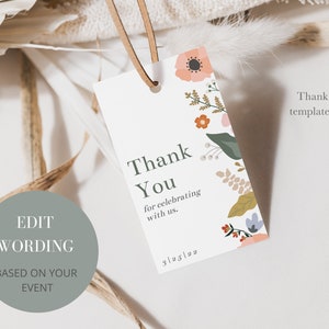 May include: A white thank you tag with a floral design in shades of pink, orange, green, and blue. The text on the tag reads "Thank You for celebrating with us. 3/25/22".