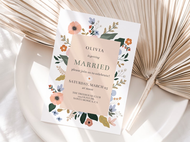 May include: A floral wedding invitation with a peach background and the text "Olivia is getting married, please join us to celebrate! Saturday, March 25 at noon, The Treehouse Club, 123 Olive Dr., Santa Monica, CA."