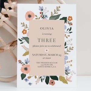 May include: A floral-themed birthday invitation for Olivia's third birthday party. The invitation features a pink background with a floral border and the text "Olivia is turning THREE please join us to celebrate! SATURDAY, MARCH 25 at noon THE TREEHOUSE CLUB 123 OLIVE DR. SANTA MONICA, CA"