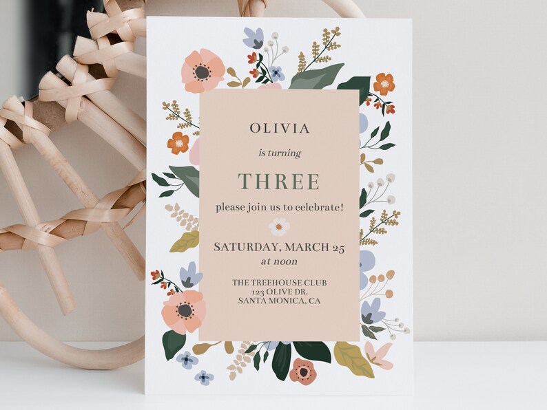 May include: A floral-themed birthday invitation for Olivia's third birthday party. The invitation features a pink background with a floral border and the text "Olivia is turning THREE please join us to celebrate! SATURDAY, MARCH 25 at noon THE TREEHOUSE CLUB 123 OLIVE DR. SANTA MONICA, CA"