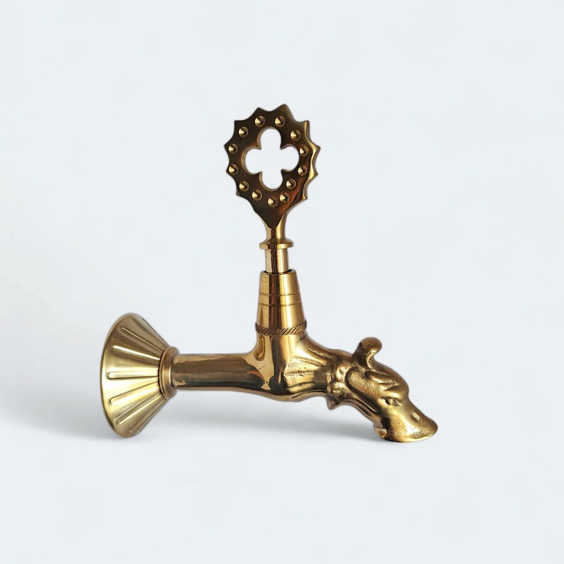Elegant brass wall tap with historical aesthetic