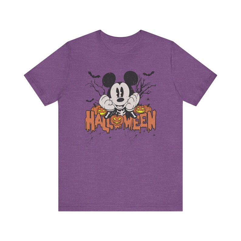 May include: Purple t-shirt with a vintage-style image of Mickey Mouse dressed as a skeleton with pumpkins and the text "HALLOWEEN".