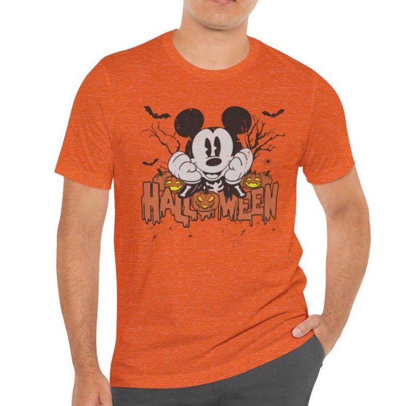 May include: Orange t-shirt with a distressed graphic of Mickey Mouse dressed as a skeleton holding pumpkins and the text "HALLOWEEN".