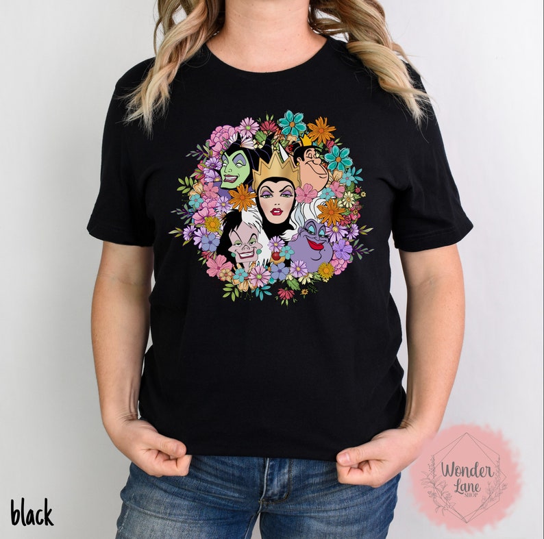 May include: Black t-shirt with a colorful floral design featuring the faces of Disney villains, including Maleficent, Cruella de Vil, and Ursula.