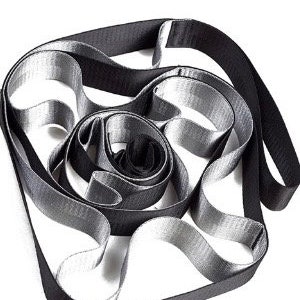 May include: A black and gray woven strap with a loop at one end. The strap is coiled and twisted into a circular shape.