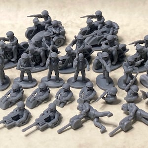 May include: A collection of gray plastic toy soldiers riding motorcycles and operating machine guns. The soldiers are posed in various action poses.