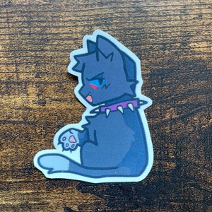 May include: A sticker of a black cat with blue eyes and a purple studded collar. The cat is sitting with its back to the viewer and has a grumpy expression.