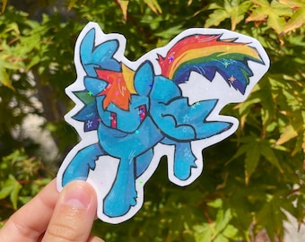 May include: A sticker featuring a blue cartoon pony with a rainbow mane and tail. The pony has red eyes and is outlined in black. The sticker has a white border and is decorated with glitter.