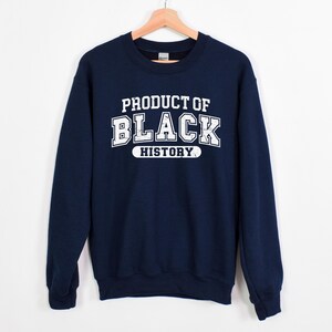 May include: Navy blue sweatshirt with white text that reads "Product of Black History".