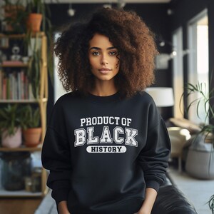 May include: A black sweatshirt with white text that reads "Product of Black History".