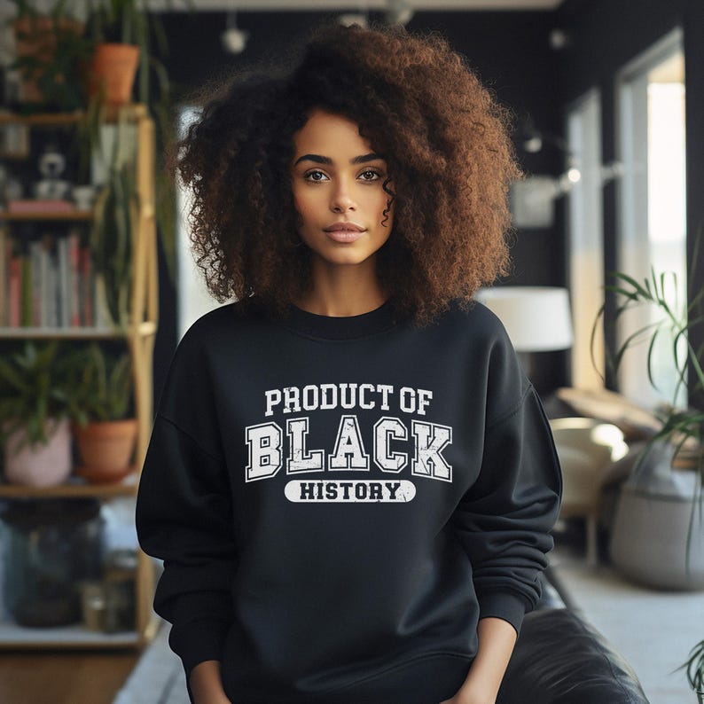 May include: A black sweatshirt with white text that reads "Product of Black History".