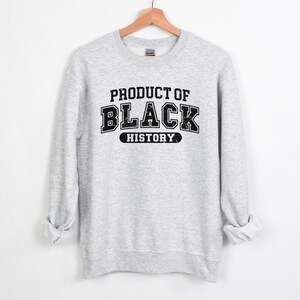 May include: Gray sweatshirt with black text that reads "Product of Black History".